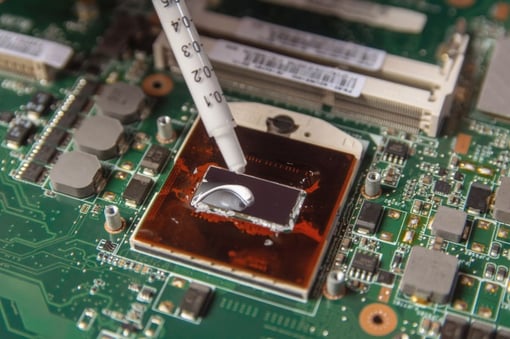 technician-applying-thermal-paste-with-syringe-cpu-processor-motherboard-laptop_9635-2914